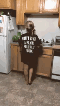 a woman wearing a black shirt that says " don t give a flyin hillbill fuck "