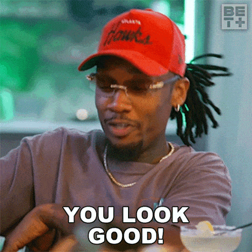 a man wearing a hawks hat and sunglasses says you look good