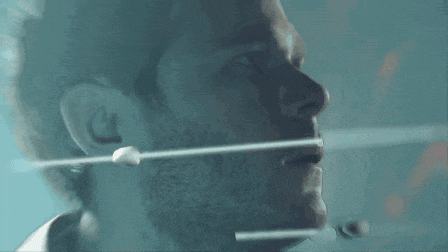 a close up of a man 's face with a bullet sticking out of it