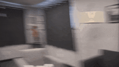 a blurry picture of a room with a person standing in the corner