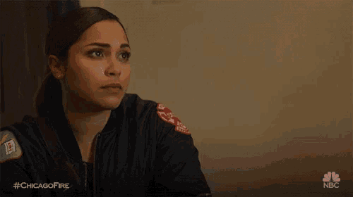 a woman in a bomber jacket with a patch on her shoulder that says ' chicago fire '