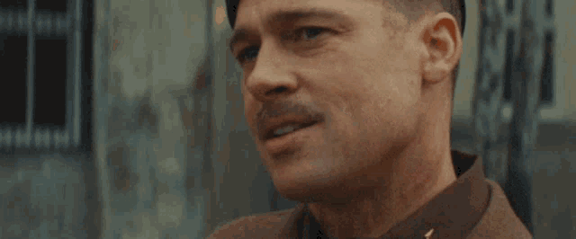 a close up of a man 's face with a mustache wearing a military uniform .