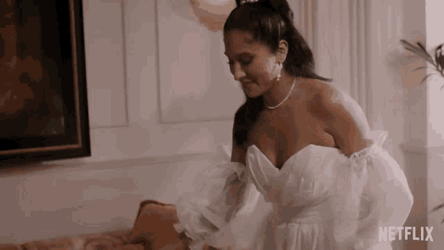 a woman in a wedding dress is standing in a room with a netflix logo in the corner