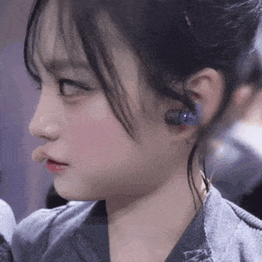 a close up of a woman 's face with earbuds in her ears