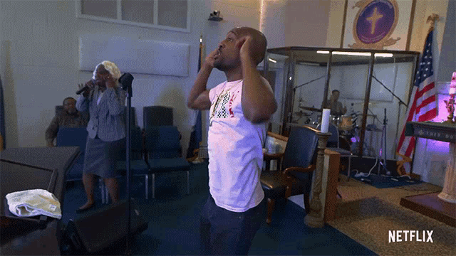 a man is standing in a church with a netflix logo on the bottom right