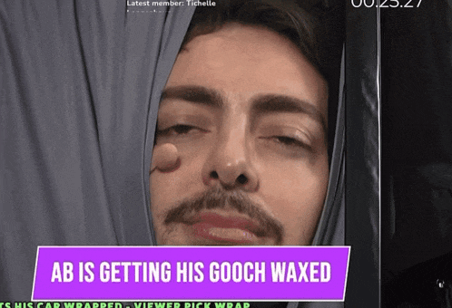 a man is getting his gooch waxed in a purple sign