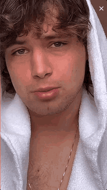 a close up of a man 's face with a x in the corner