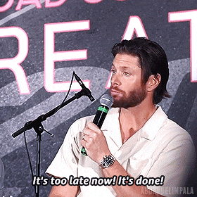 a man holding a microphone says it 's too late now