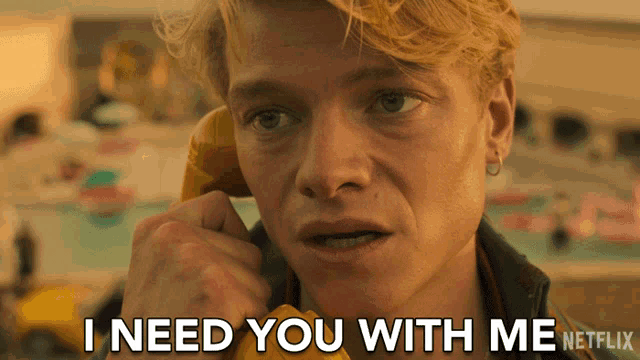 a man talking on a phone with the words " i need you with me " written below him
