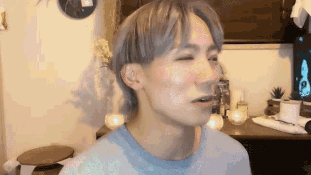 a close up of a man 's face with his eyes closed and his mouth open