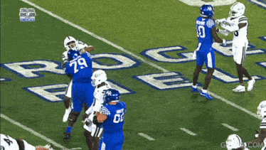 a football player wearing number 79 is being tackled