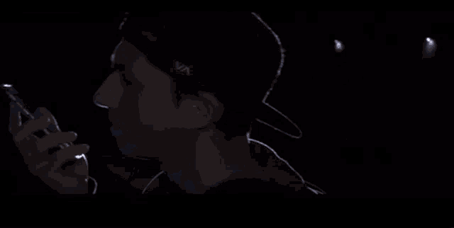 a man and a woman are taking a picture of themselves in the dark with a flashlight .