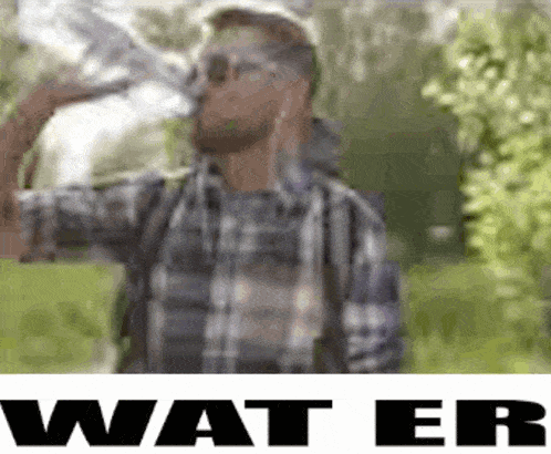 a man in a plaid shirt is drinking water from a bottle in a park