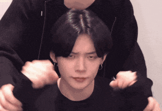 a man is holding another man 's head with his hands