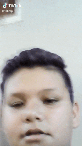 a close up of a boy 's face with a tiktok watermark on it