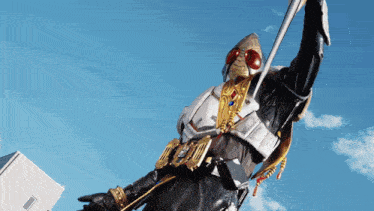 a man in a knight costume is holding a sword in front of a blue sky