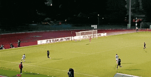 soccer players on a field with a sign that says it 's team jay time