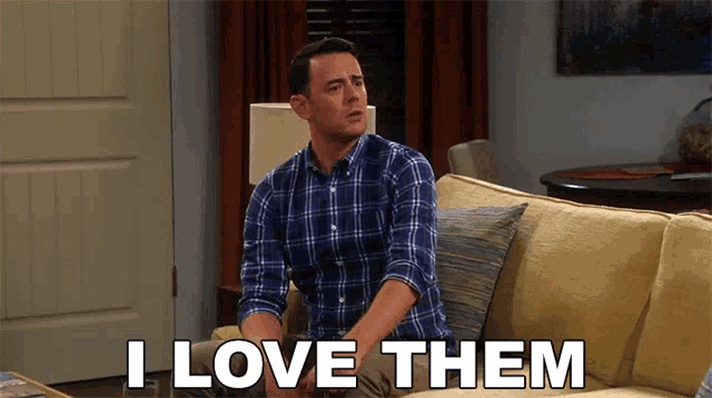a man sitting on a couch with the words i love them on the bottom