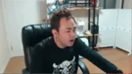 a man wearing a black shirt with a skull on it is sitting in a chair .