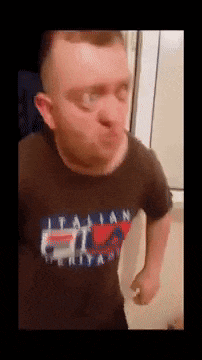 a man wearing a black t-shirt with the word italian on it