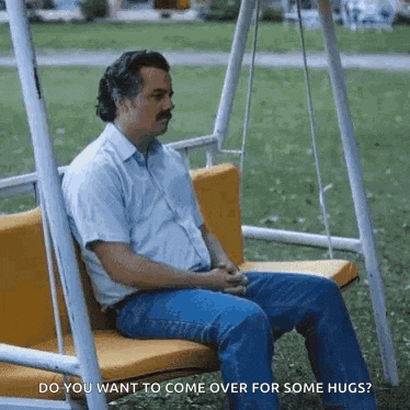 a man is sitting on a swing and asking do you want to come over for some hugs