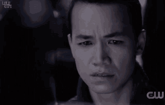 a close up of a man 's face with the letters cw on the bottom right