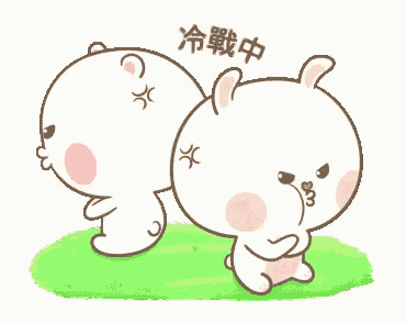 a couple of rabbits are standing next to each other in the grass .