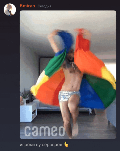 a picture of a man holding a rainbow flag with cameo in the bottom right corner