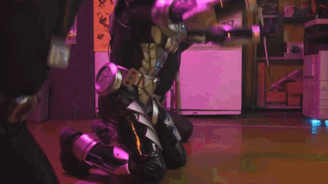 a person in a superhero costume kneeling on the floor