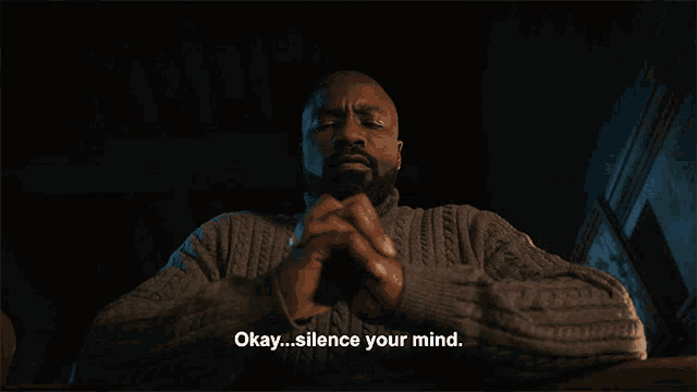 a man in a grey sweater with his eyes closed and the words focus written below him