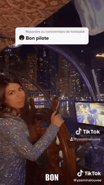 a woman is holding a steering wheel in front of a screen that says tiktok