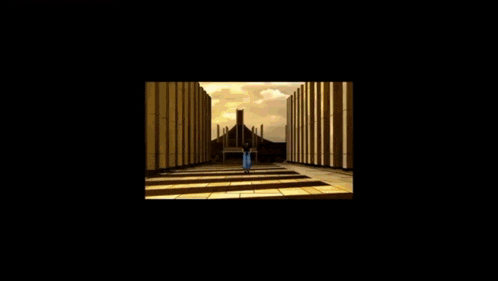 a man in a black shirt and blue pants is walking down a hallway