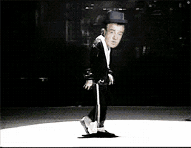 a man in a hat is dancing on a white surface