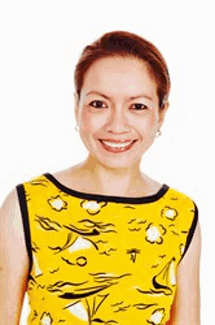 a woman is wearing a yellow dress and smiling