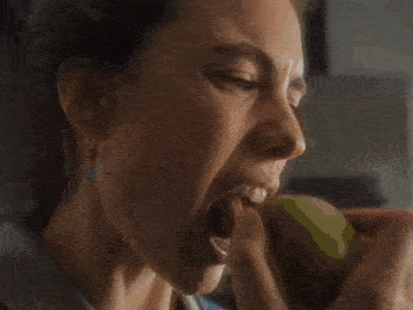 a woman is taking food out of a fridge .