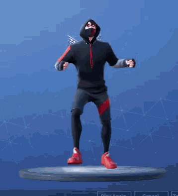 a man wearing a mask and a hoodie is dancing on a stage .