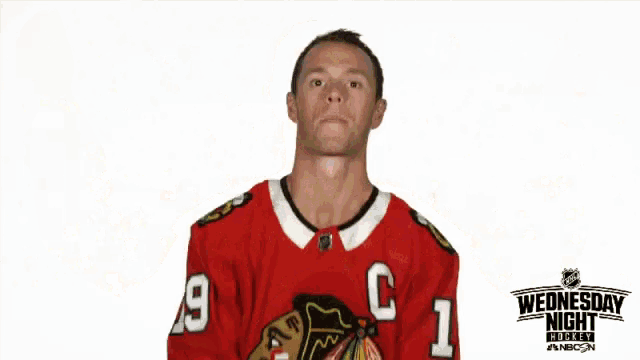 a hockey player in a red jersey with the letter c on it