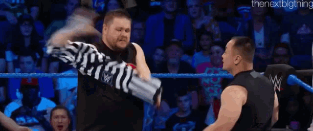 a referee in a black and white striped shirt with ko on the front