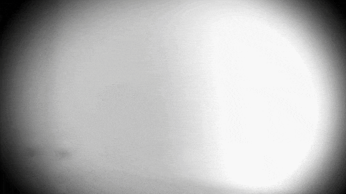 a black and white photo of a circle with a shadow on it .