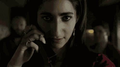 a close up of a woman talking on a cell phone with the words empieza el matriarcado above her
