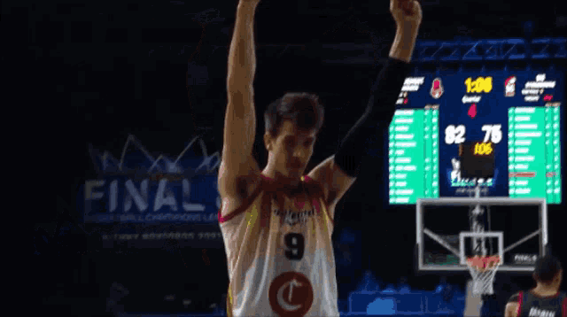 a basketball player with the number 9 on his jersey is celebrating