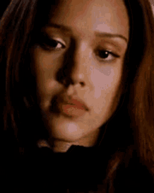 a close up of a woman 's face with a black background