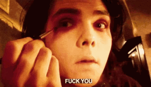 a close up of a person applying makeup with the words fuck you visible