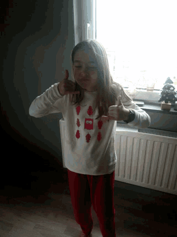 a little girl wearing a shirt that says coca cola on it