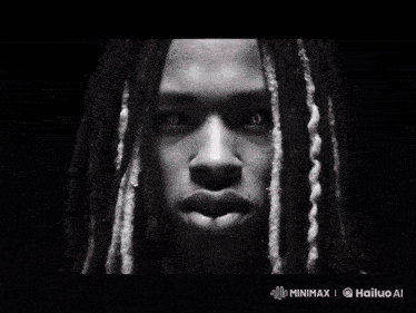 a black and white photo of a man with dreadlocks and red lightning