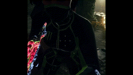 a man is holding a gun in his hand in a dark room in a video game .