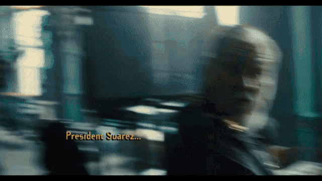 a blurry picture of a person with the name president suarez written on the bottom