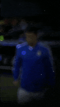 a blurry picture of a person wearing a blue shirt