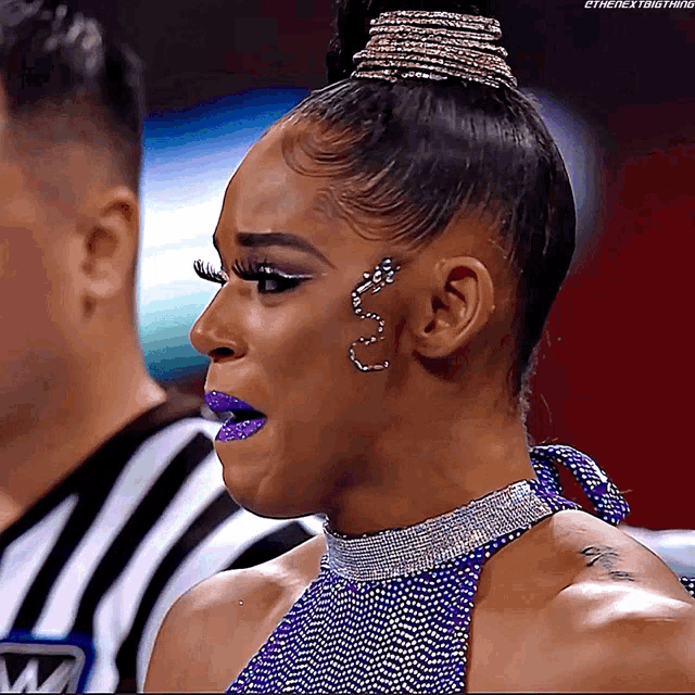 a woman wearing purple lipstick and earrings is standing next to a referee