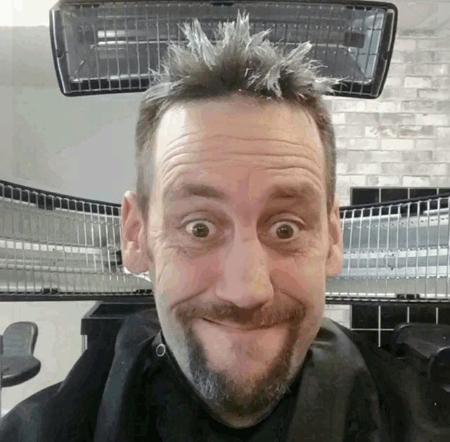 a man with a beard making a funny face with his eyes wide open